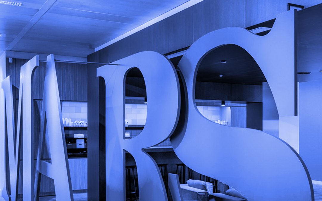 Giant MARS letters standing in an office lobby, tinted blue